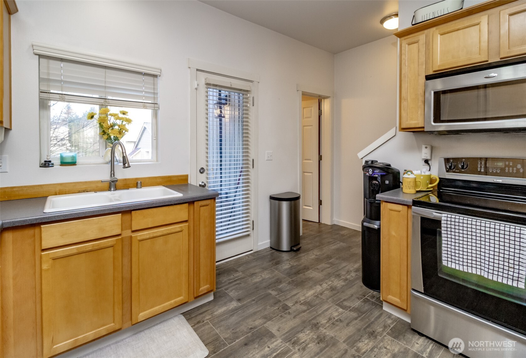 5305 Military Road East, Unit A Tacoma, WA 98446 - Photo 10 of 39 a kitchen with stainless steel appliances a stove a sink and a microwave