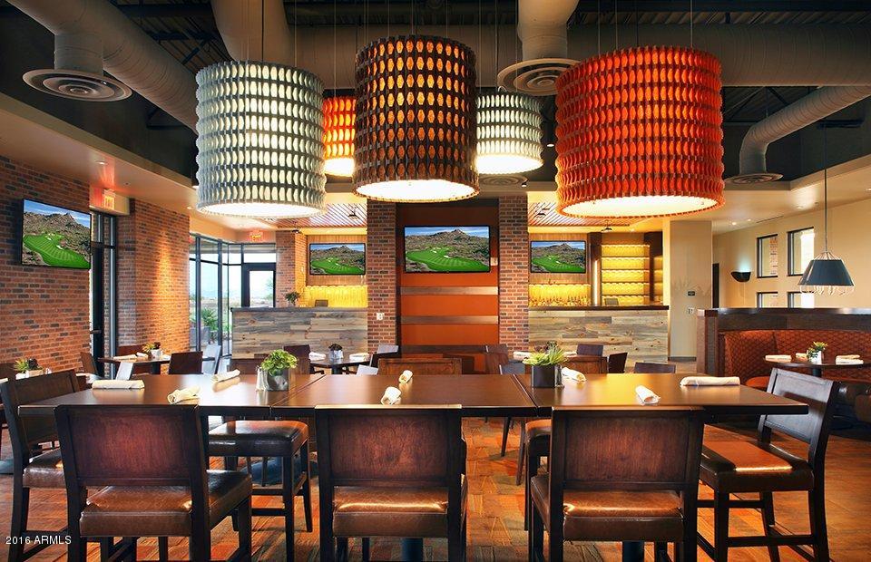 6656 West Springfield Way Florence, AZ 85132 - Photo 6 of 26 a dining hall with stainless steel appliances a dining table and chairs with wooden floor