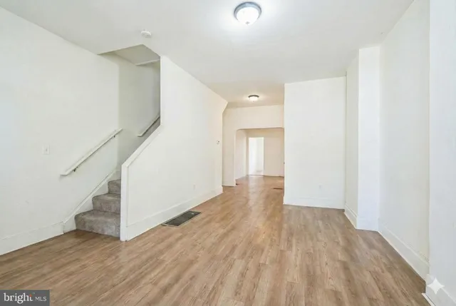 a view of a hallway with wooden floor and entryway