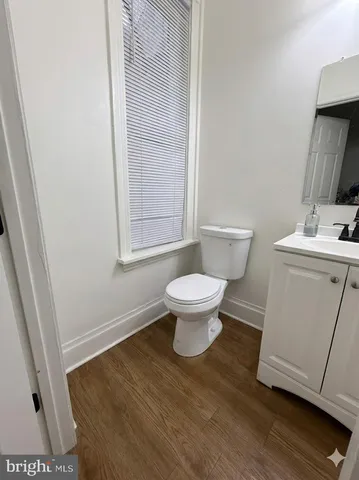 a bathroom with a sink toilet and a mirror