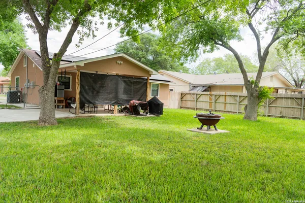 a view of a backyard with a garden and trees