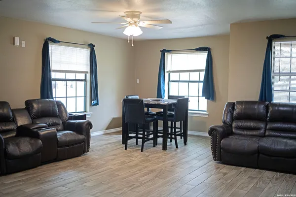 a view of a livingroom with furniture window and wooden floor