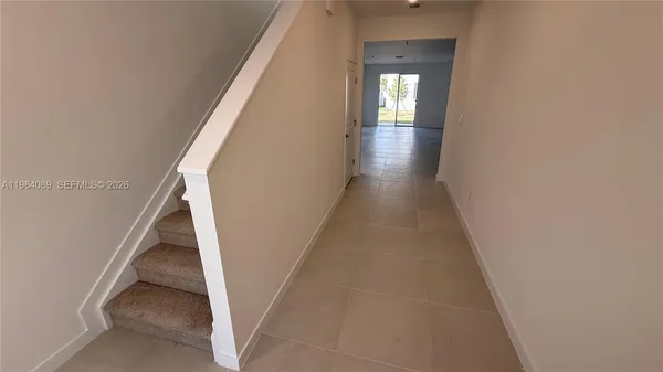 a view of a hallway with wooden floor and entryway