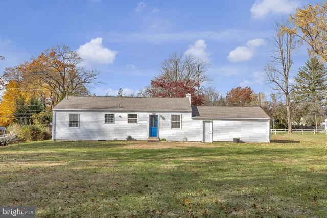 a house view with a sitting space and garden