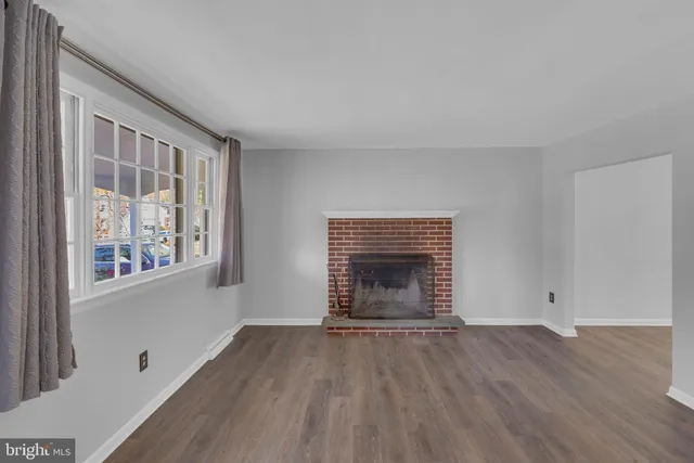 an empty room with windows fire place and windows