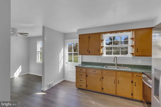 a kitchen with a sink window and cabinets