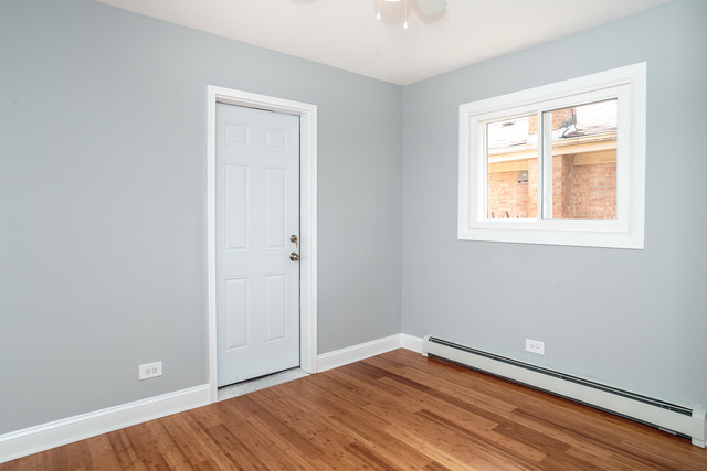 601 Highview Avenue Addison, IL 60101 - Photo 14 of 50 a view of an empty room with wooden floor and a window