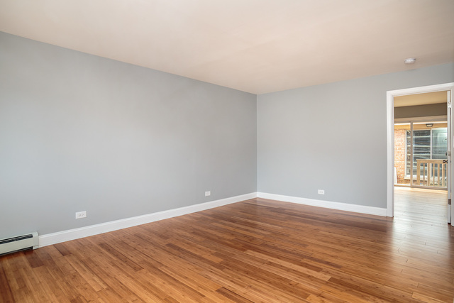 601 Highview Avenue Addison, IL 60101 - Photo 17 of 50 a view of an empty room with wooden floor and a window