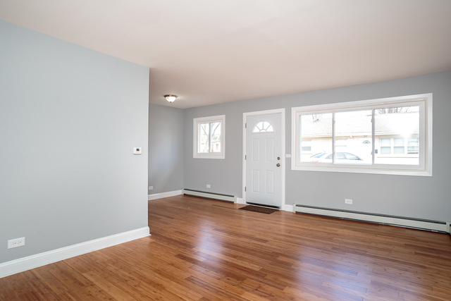 601 Highview Avenue Addison, IL 60101 - Photo 19 of 50 an empty room with wooden floor and windows