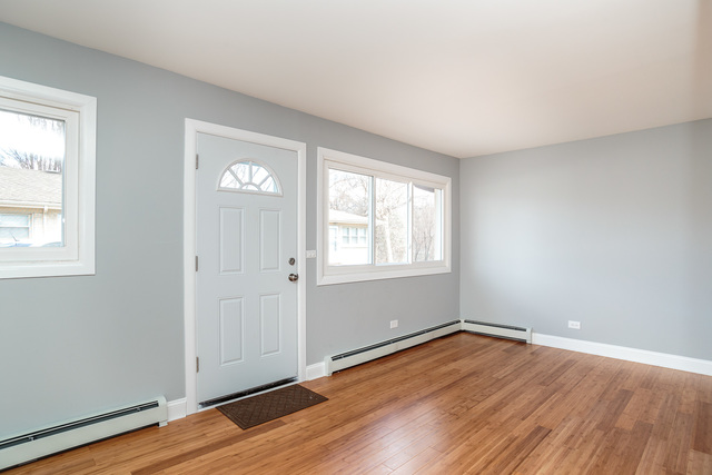 601 Highview Avenue Addison, IL 60101 - Photo 20 of 50 an empty room with wooden floor and windows