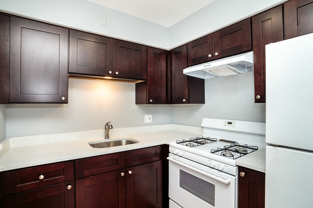601 Highview Avenue Addison, IL 60101 - Photo 23 of 50 a kitchen with wooden cabinets and white appliances