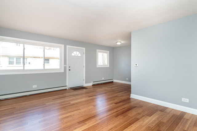601 Highview Avenue Addison, IL 60101 - Photo 30 of 50 an empty room with wooden floor and windows