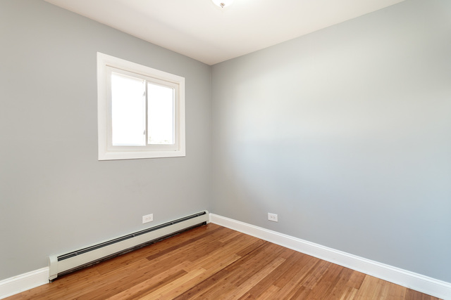 601 Highview Avenue Addison, IL 60101 - Photo 33 of 50 an empty room with wooden floor and windows