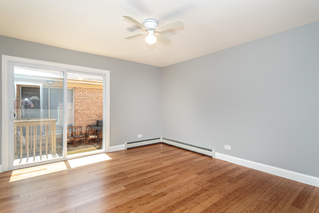 601 Highview Avenue Addison, IL 60101 - Photo 34 of 50 an empty room with wooden floor and windows