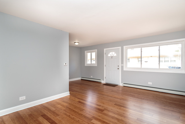 601 Highview Avenue Addison, IL 60101 - Photo 40 of 50 an empty room with wooden floor and windows