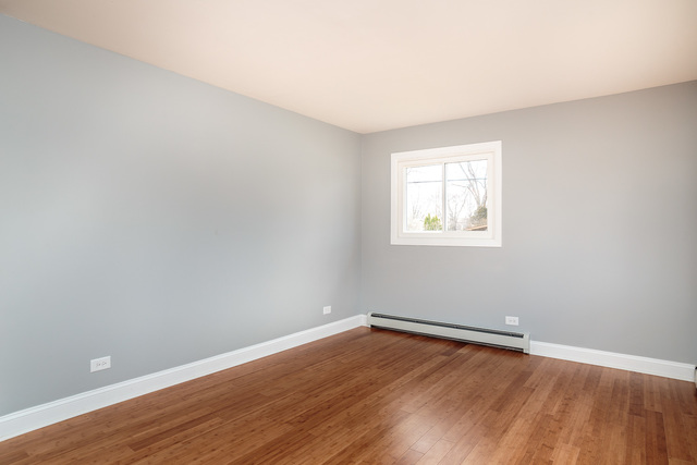 601 Highview Avenue Addison, IL 60101 - Photo 5 of 50 an empty room with wooden floor and windows