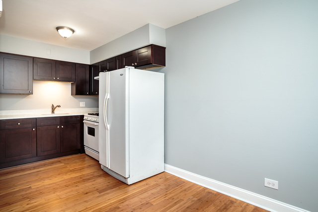 601 Highview Avenue Addison, IL 60101 - Photo 43 of 50 a kitchen with a refrigerator and a stove top oven