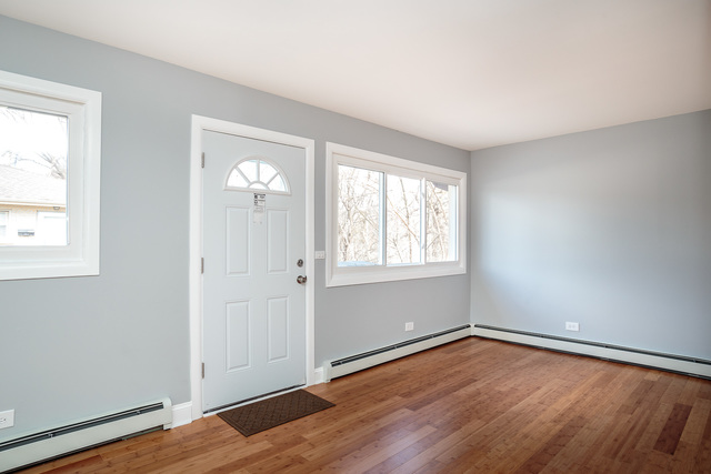 601 Highview Avenue Addison, IL 60101 - Photo 45 of 50 an empty room with wooden floor and windows
