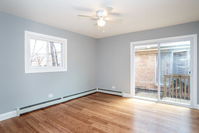 601 Highview Avenue Addison, IL 60101 - Photo 46 of 50 an empty room with wooden floor and a ceiling fan