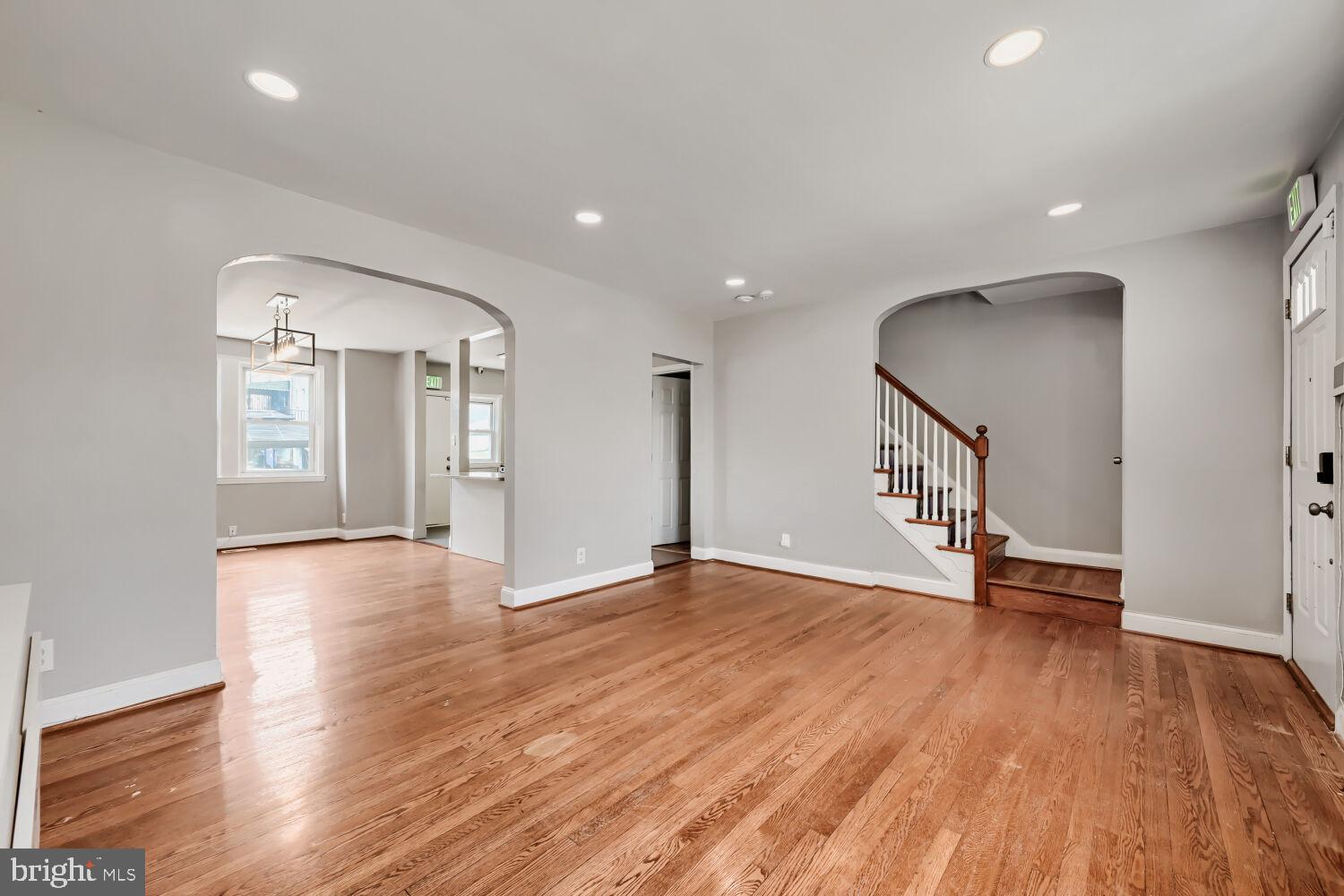 1014 Lyndhurst Street Baltimore, MD 21229 - Photo 5 of 29 a view of an empty room with wooden floor and a window