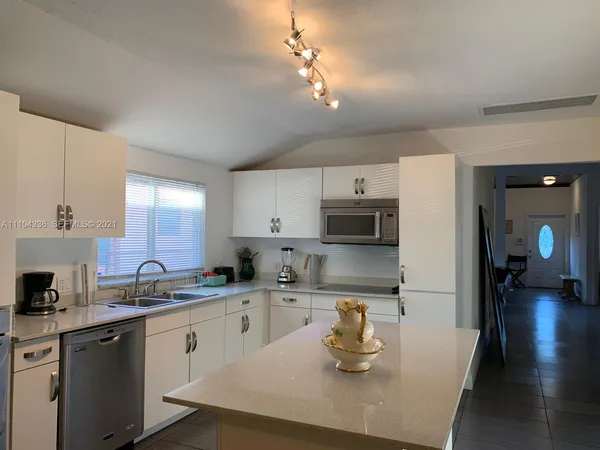 a kitchen with a sink a stove and cabinets