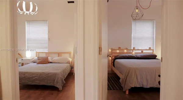 a bedroom with a bed next to a window with outer view and couch