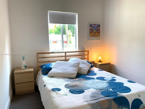 a bed sitting in a bedroom next to a window