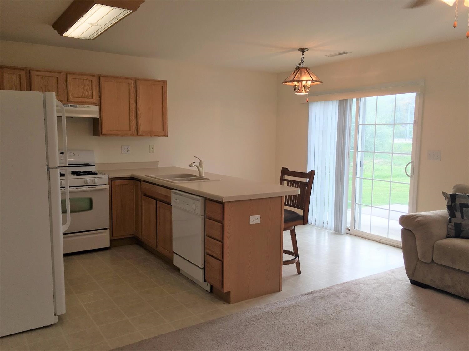 369 South Boo Road, Unit D Chesterton, IN 46304 - Photo 5 of 10 a kitchen with stainless steel appliances granite countertop a sink a stove and a refrigerator
