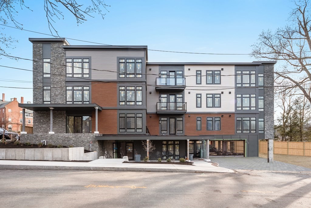 20 Kinmonth Road, Unit 106 Newton, MA 02468 - Photo 11 of 21 a front view of a building with a street