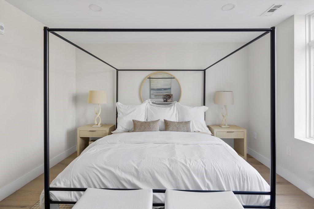 20 Kinmonth Road, Unit 106 Newton, MA 02468 - Photo 9 of 21 a bedroom with a bed and a mirror