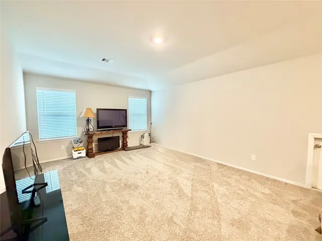 a view of a livingroom with a computer on a desk and chair