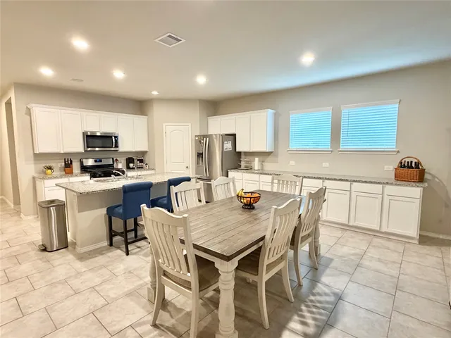 a kitchen with a stove a sink a counter top space and appliances