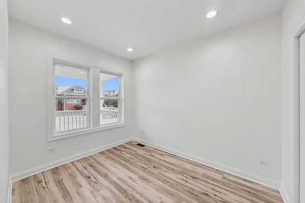 a view of an empty room and wooden floor