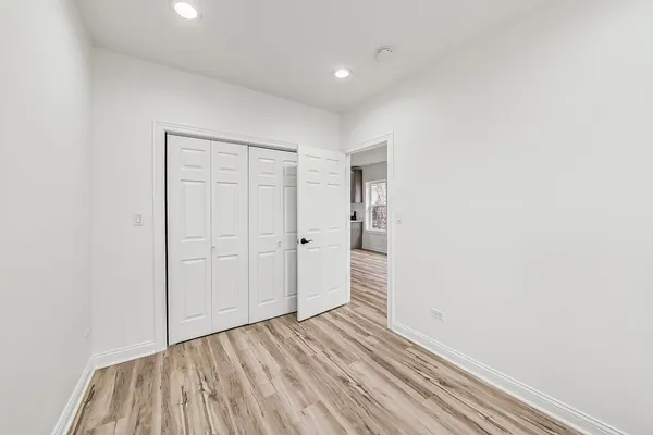 a view of a room with wooden floor and white walls