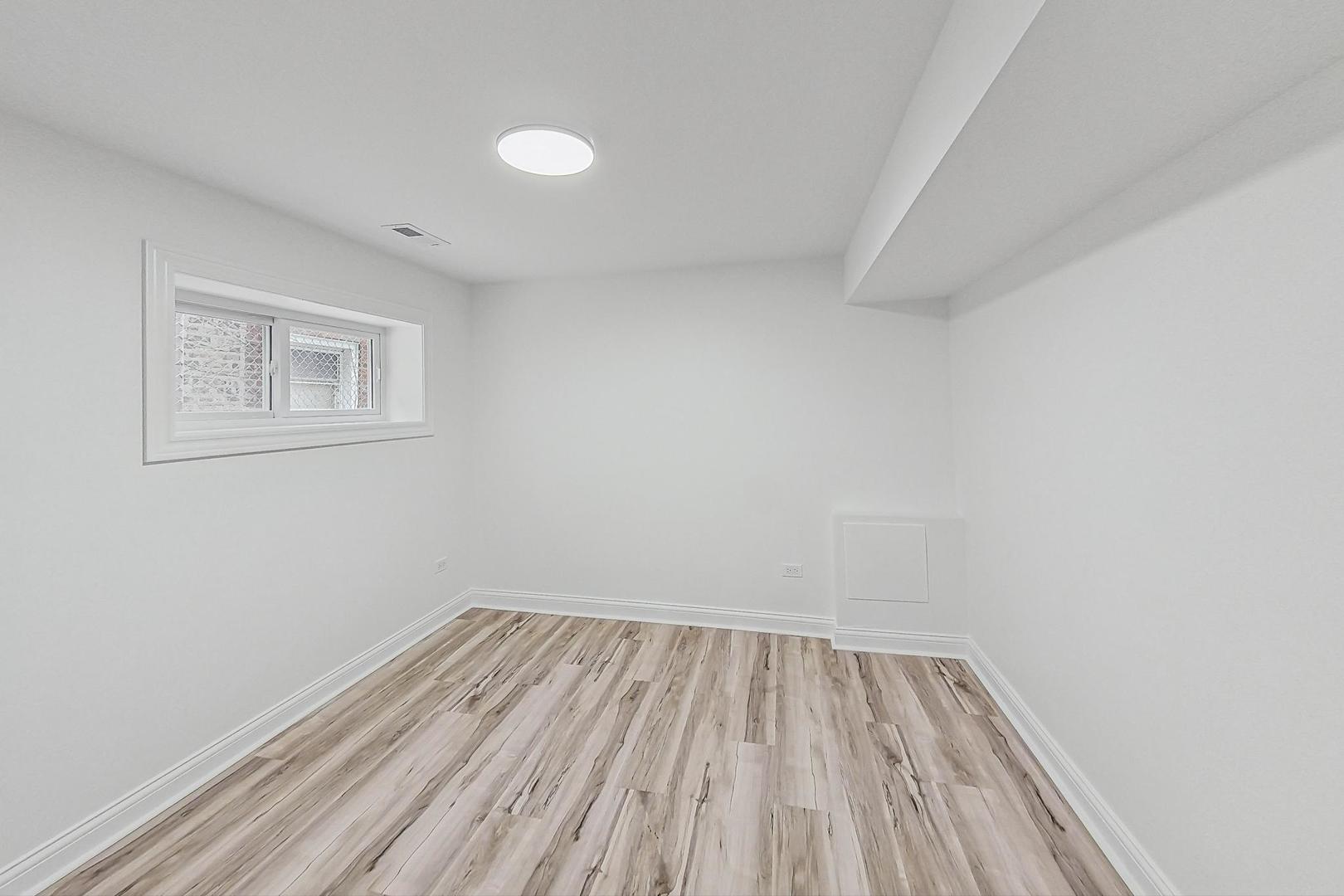 5619 South California Avenue Chicago, IL 60629 - Photo 22 of 31 a view of a room with wooden floor and white walls