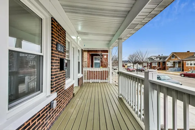 a large kitchen with stainless steel appliances wooden floor and a stove top oven