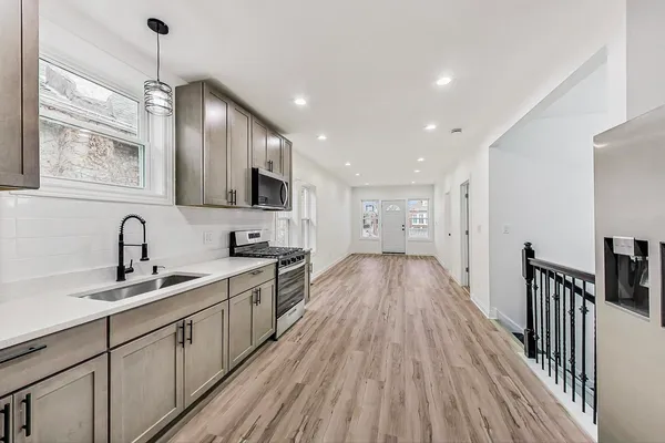 a view of a hallway with wooden floor
