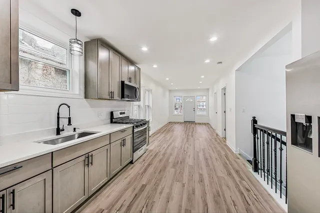 a view of a hallway with wooden floor