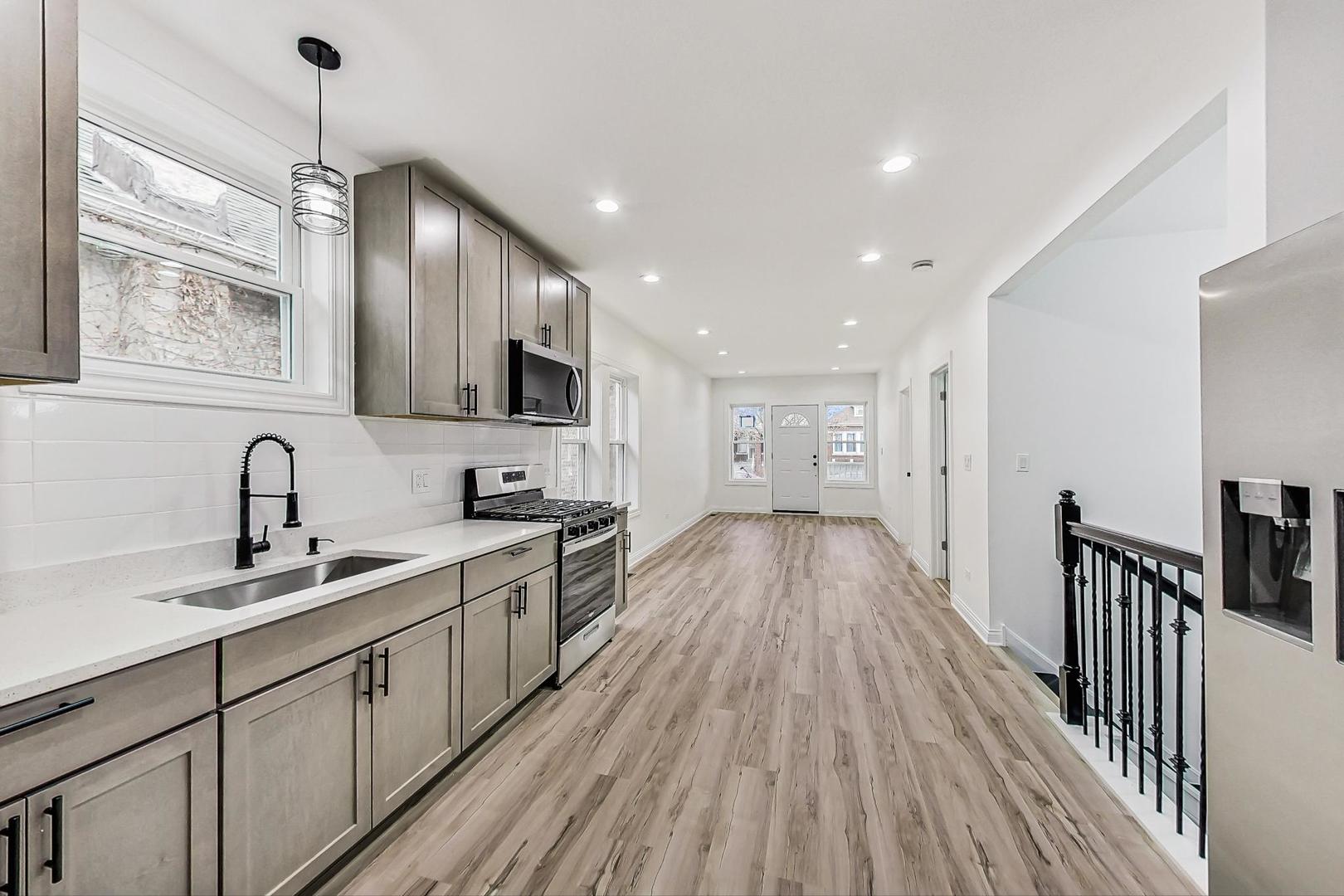 5619 South California Avenue Chicago, IL 60629 - Photo 10 of 31 a kitchen with granite countertop a sink stove refrigerator and cabinets