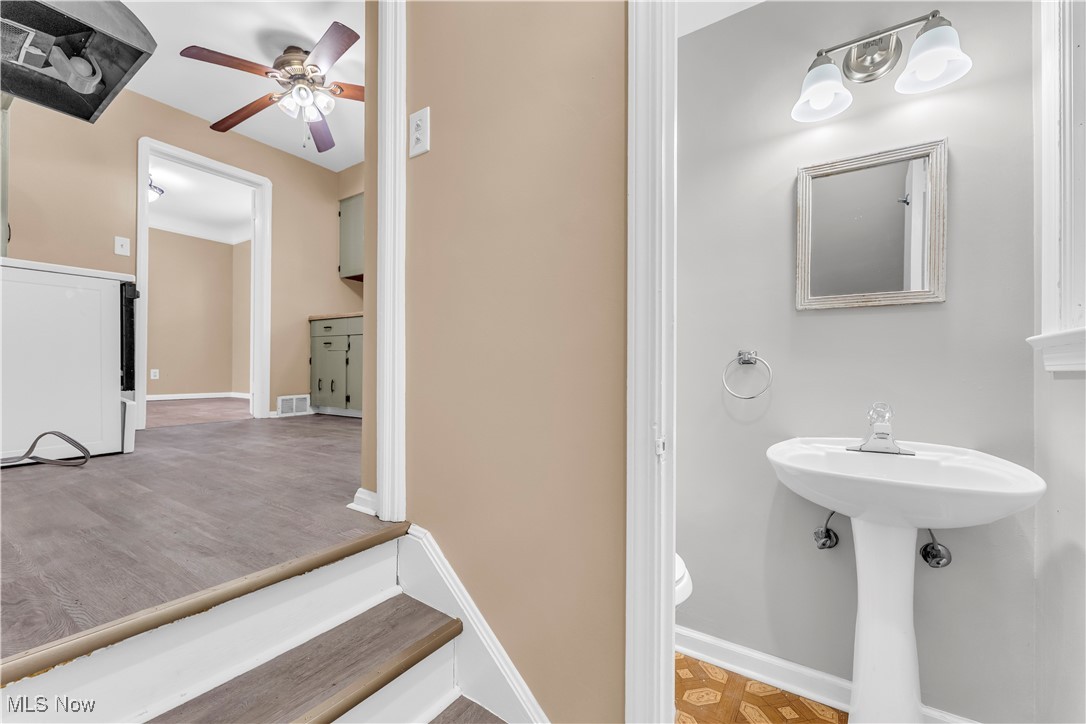 4693 Liberty Road South Euclid, OH 44121 - Photo 14 of 33 Half bath with a ceiling fan and light wood-style floors