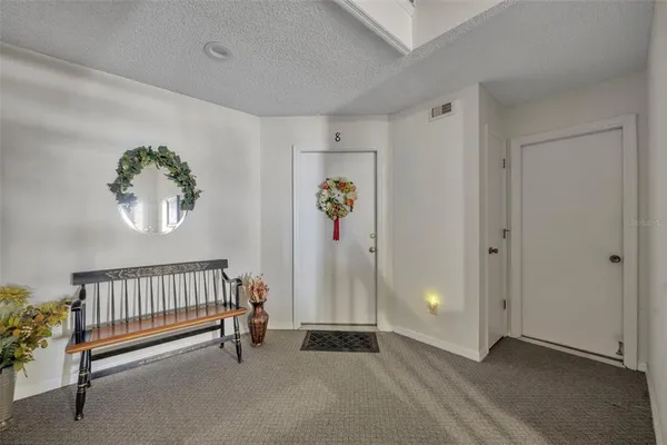 a view of an empty room with window and stairs