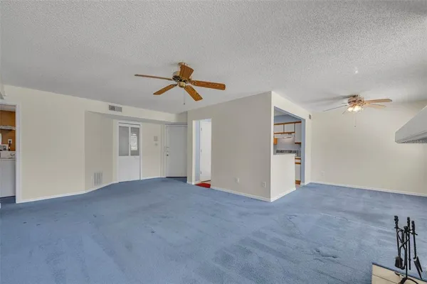 a view of empty room with ceiling fan