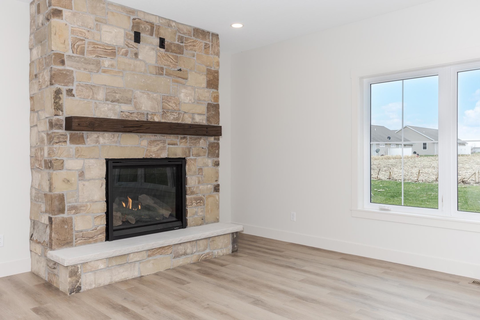 204 Stallion Way Goodfield, IL 61742 - Photo 23 of 53 a view of an empty room with wooden floor and a fireplace
