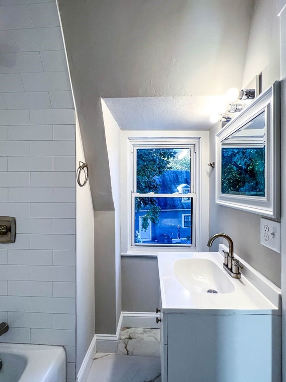 67 Waltham Street Maynard, MA 01754 - Photo 18 of 29 a bathroom with a sink mirror and tub