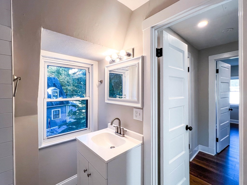 67 Waltham Street Maynard, MA 01754 - Photo 19 of 29 a bathroom with a sink mirror and a window