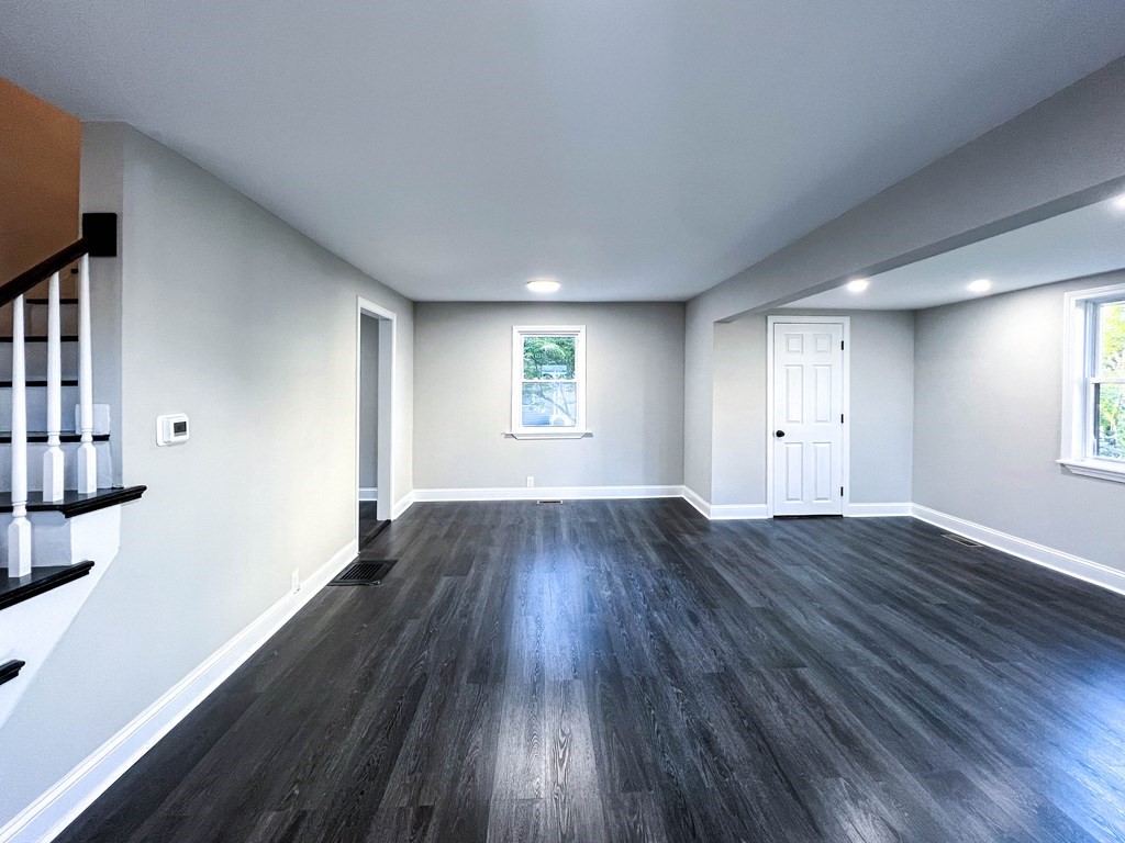 67 Waltham Street Maynard, MA 01754 - Photo 3 of 29 an empty room with wooden floor and windows