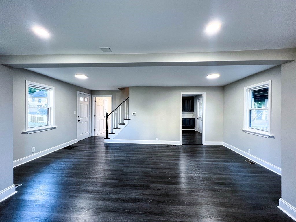 67 Waltham Street Maynard, MA 01754 - Photo 4 of 29 an empty room with wooden floor and windows