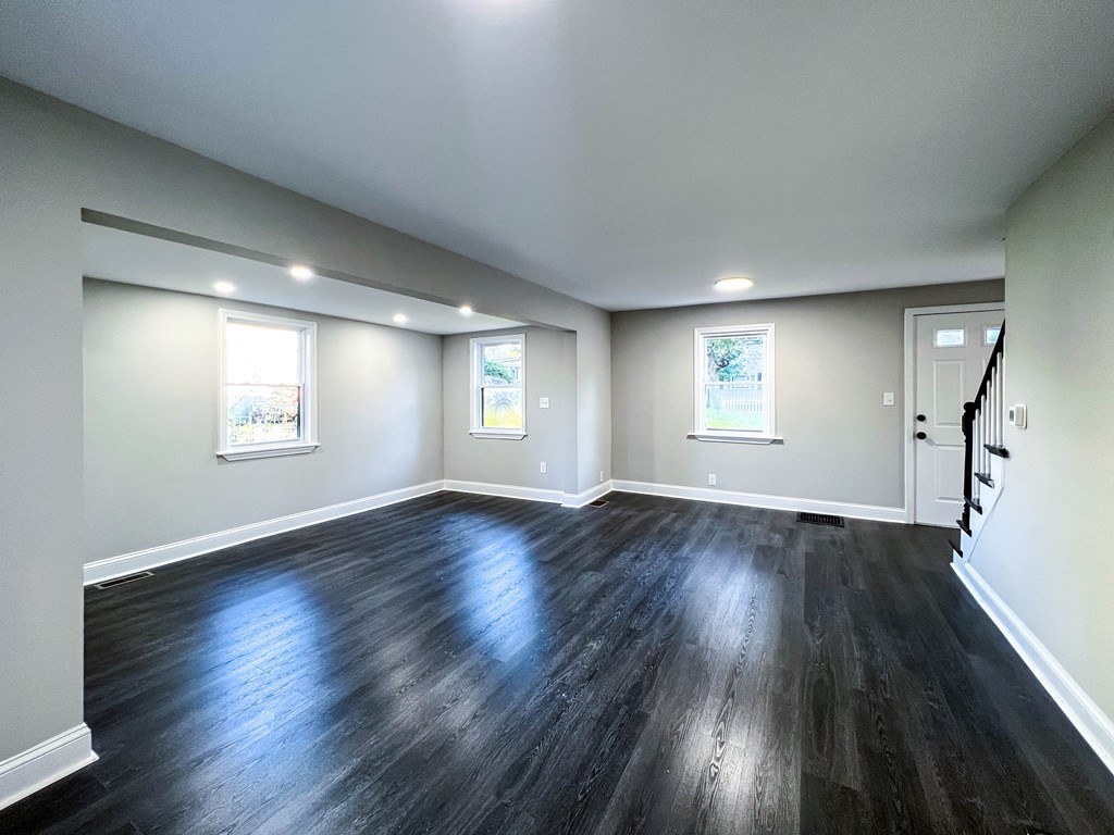 67 Waltham Street Maynard, MA 01754 - Photo 5 of 29 an empty room with wooden floor and windows