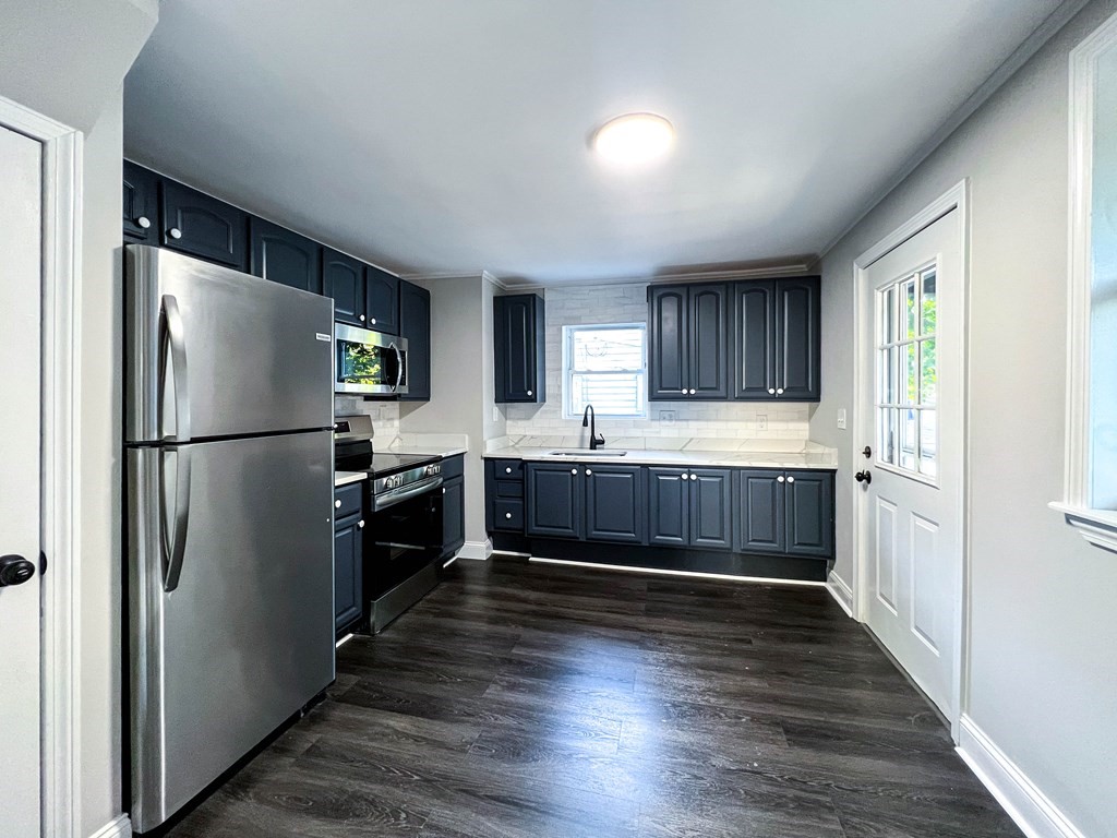 67 Waltham Street Maynard, MA 01754 - Photo 6 of 29 a kitchen with granite countertop stainless steel appliances a refrigerator and a sink
