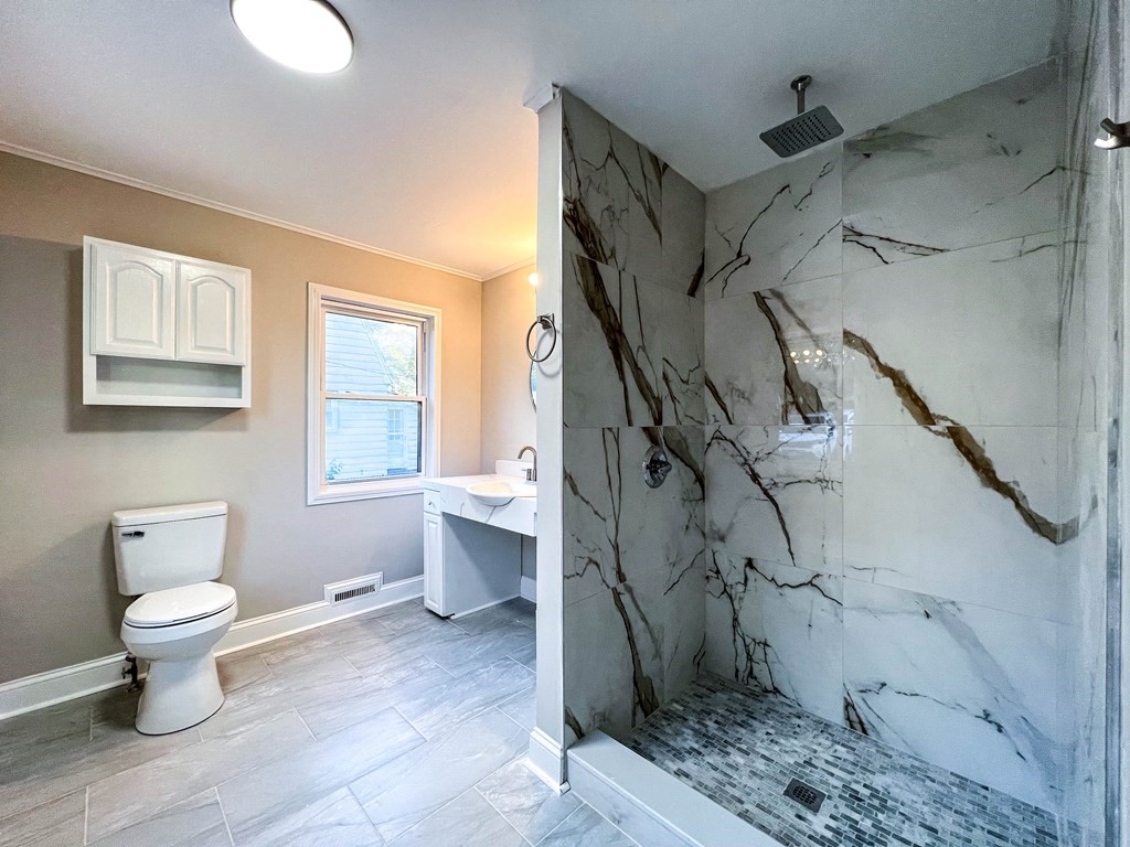 67 Waltham Street Maynard, MA 01754 - Photo 9 of 29 a bathroom with a toilet sink and a shower